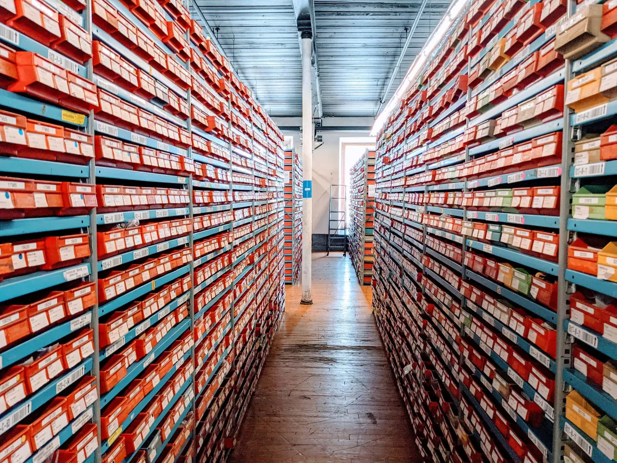 Long aisles of shelving packed with labelled, barcoded parts bins